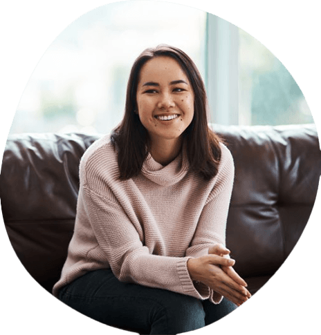 a woman smiling while speaking with her therapist