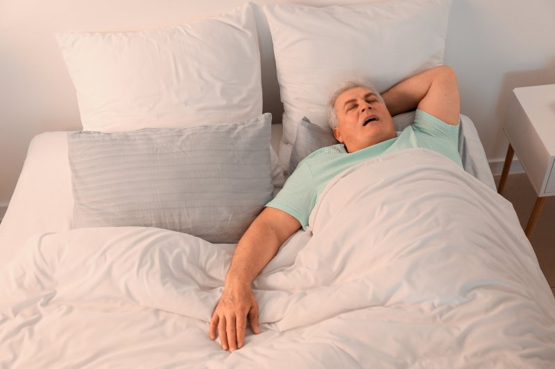 older man asleep and snoring